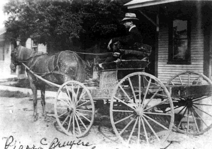 Mr. Bruyère was postmaster from 1924 to 1956. The building on the right appears to be the post office which was destroyed by fire in 1932.